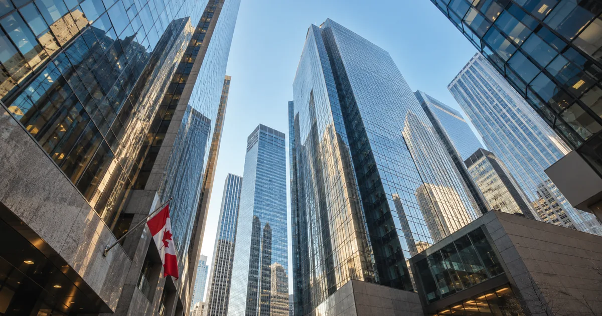 Glass office towers and a Canadian flag illustrating Canadian bank mortgage pricing